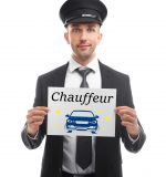 Young man standing with banner CHAUFFEUR on white background
